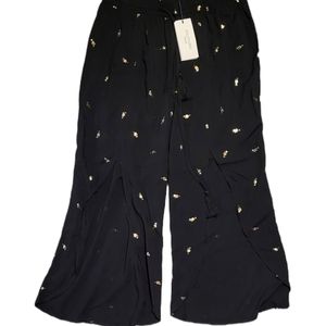 Solitaire Swim black cover up pants with gold cocktail glass pattern